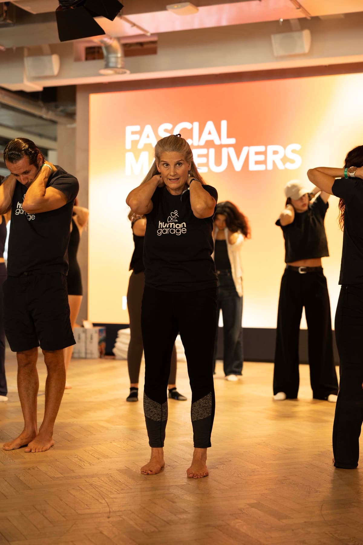 Carolyn Wade guiding a group through fascia manoeuvres