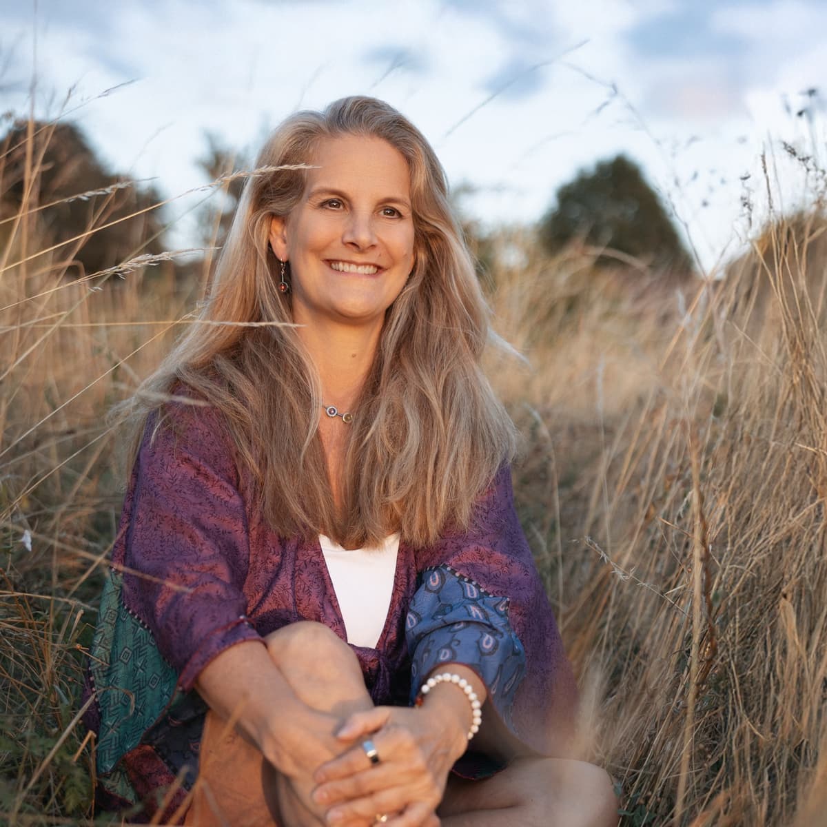 Carolyn Wade sitting in long grass
