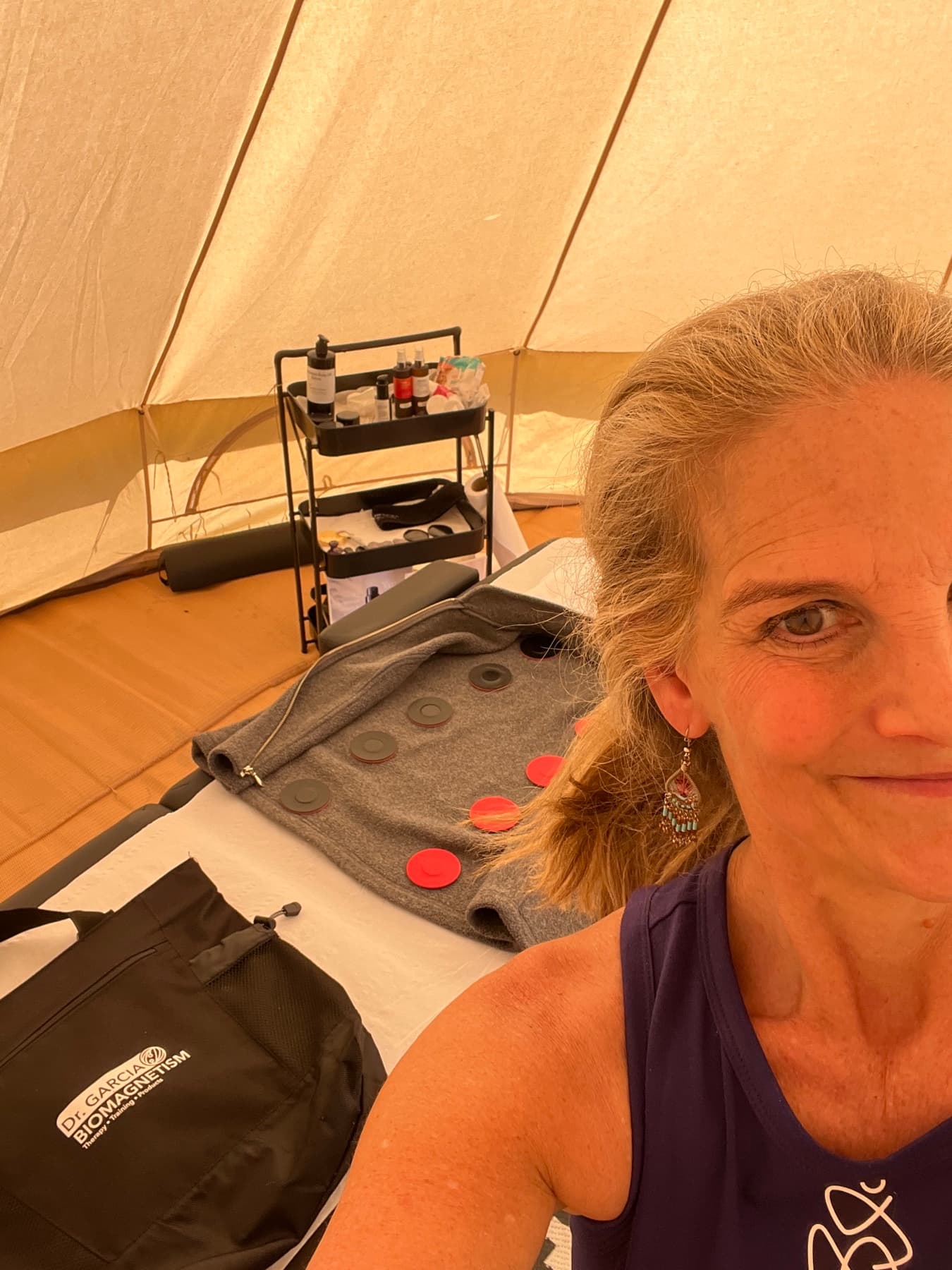 Carolyn Wade in a treatment space with biomagnetism equipment
